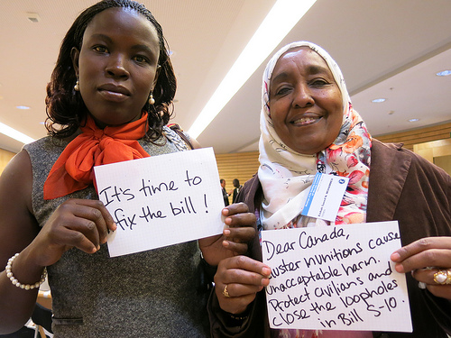 CMC Campaigners Mystical Lagua from the Uganda Landmine Survivors Association and Aisha Saeed from the Yemen Mine Awareness Association (from left to right) call on Canada to fix the bill.